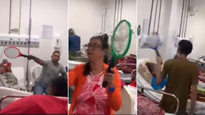 Imagem mostra uma montagem em que três pessoas usam raquetes elétricas para se defenderem de mosquitos, dentro de leito do Hospital Getúlio Vargas, em Pernambuco.