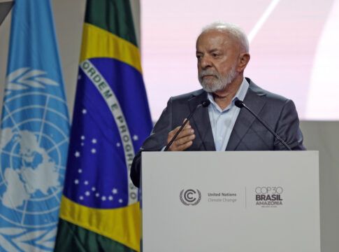 Lula fala em um púlpito, com bandeiras do Brasil e da ONU ao fundo, durante um evento oficial sobre clima.