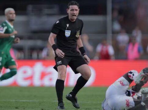 Árbitro Ramon Abetti Abel de pé, ao lado de um jogador do São Paulo no chão, durante partida contra o Palmeiras