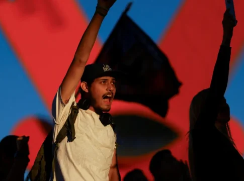 Um manifestante de punho erguido grita palavras de ordem no México, em protesto contra o governo local
