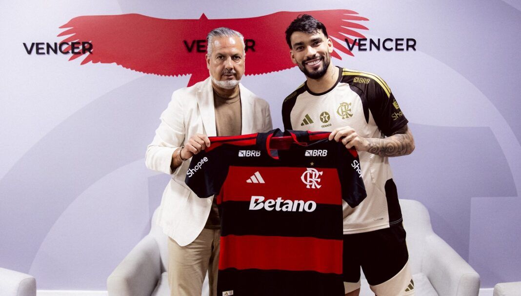 Paquetá segura a camisa do Flamengo ao lado de José Boto