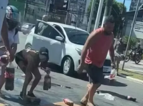 Carga de refrigerante cai de caminhonete e pessoas ajudam a recolher produtos em Vitória; veja vídeo